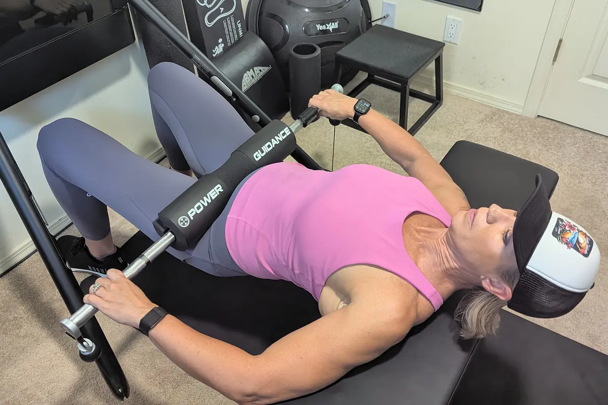 Jill doing a hip thrust on a bench with a padded bar across her hips