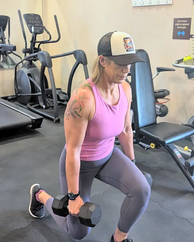 Jill doing a lunge holding two dumbbells